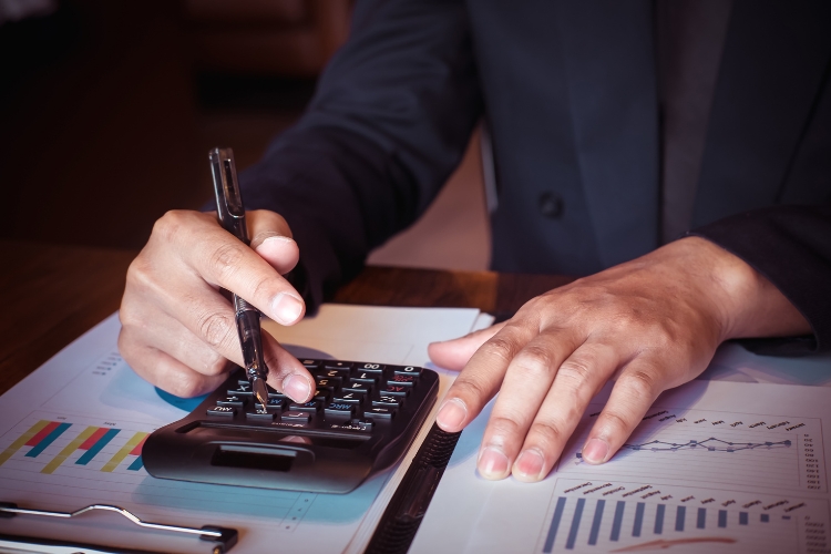 man using calculator focus