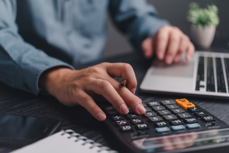 man using calculator focus