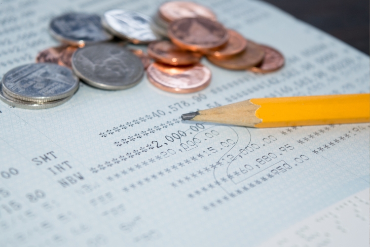 coins on paper and pencil focus