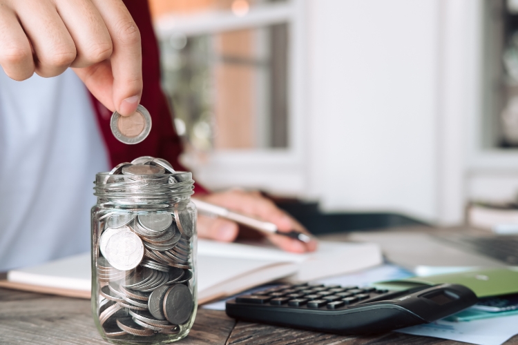 man adding coins into the jar