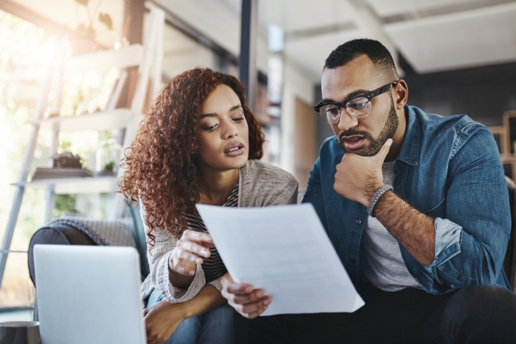 man and woman reading from paper focus