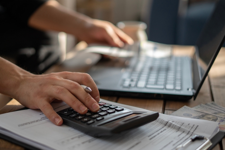 man using calculator focus